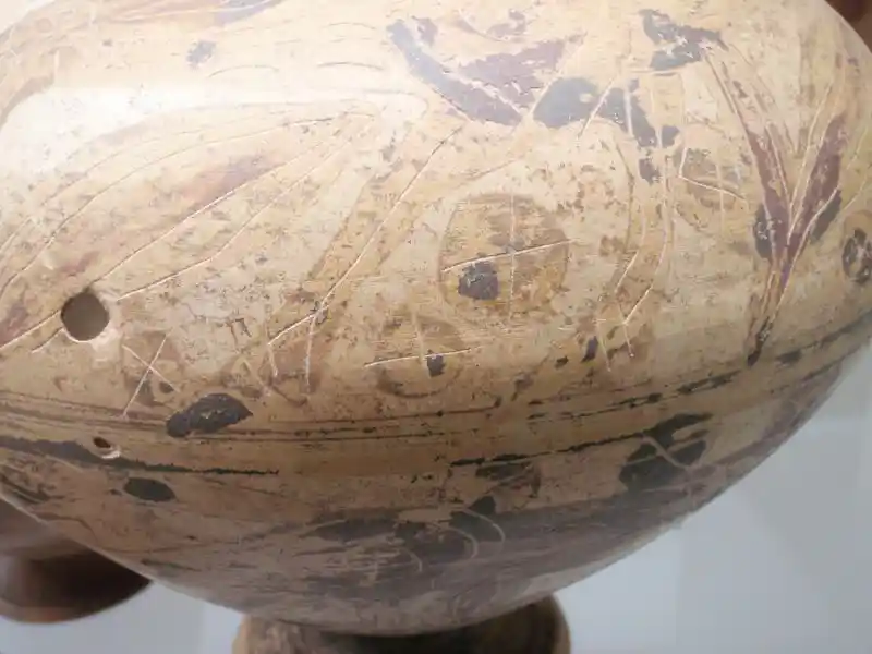 Cross on a circle, solar discs on a vase, located at the National Etruscan Museum of Villa Giulla, Rome.